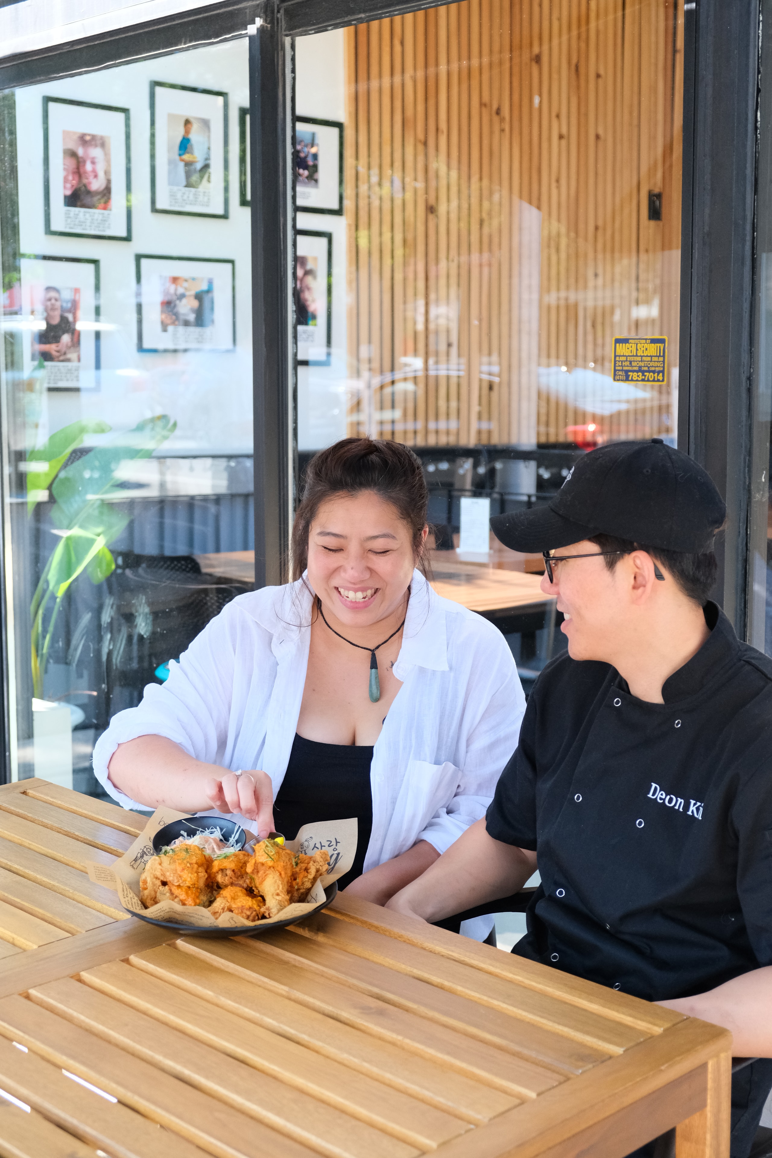 Sarang Kitchen staff serving fried chicken at the restaurant