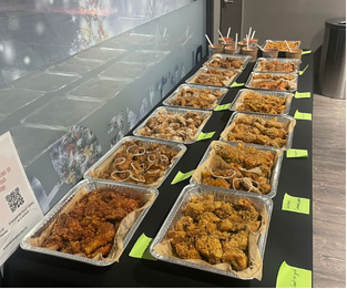 Sarang Kitchen catering chicken lineup on trays